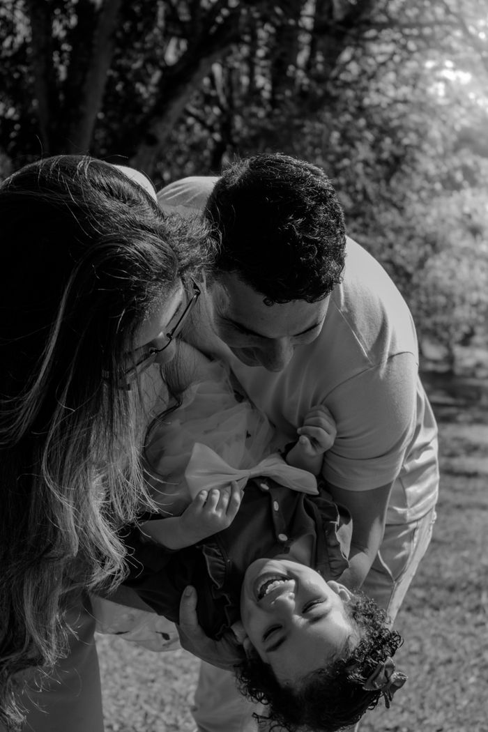 A joyful family moment captured outdoors in São Paulo, showing happiness and connection.